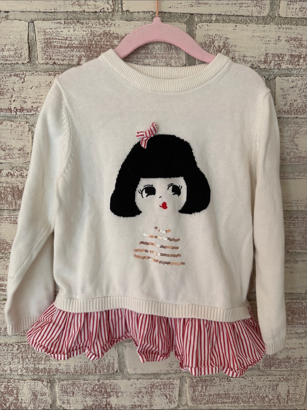 Girls White Knit Sweater with Doll Motif and Red Stripe Ruffle